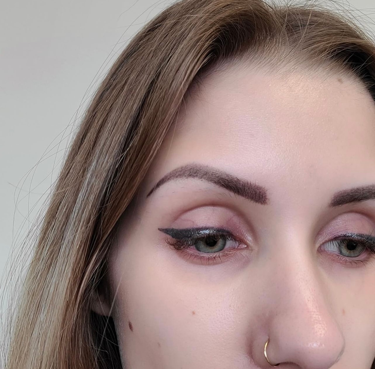 Winged lash line eyeliner — clean flick, lasting result.